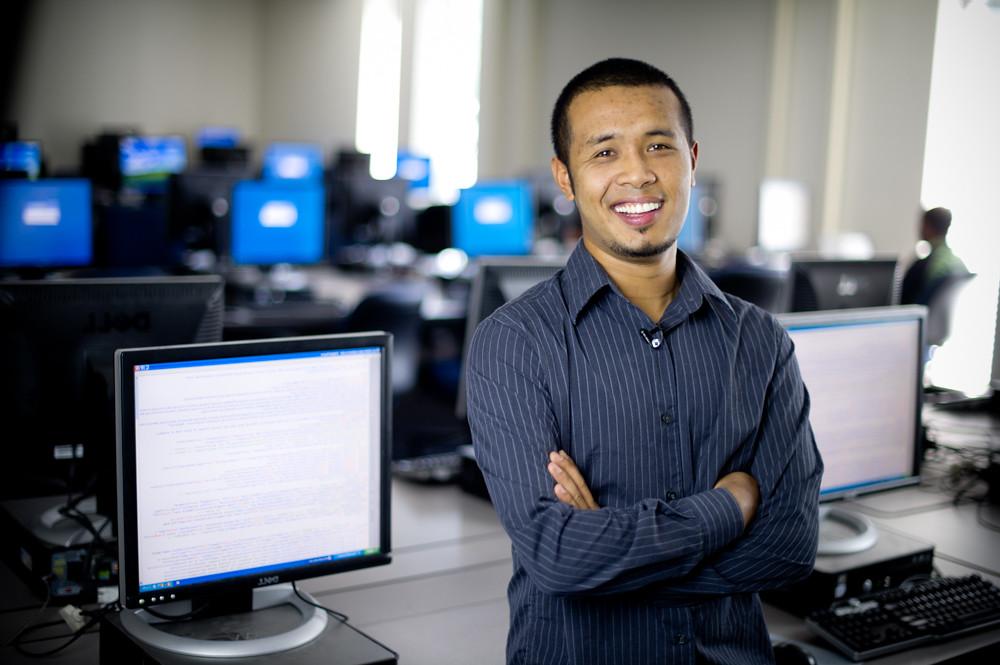 Man standing in front of computers.