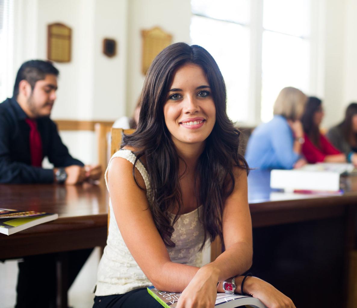 Woman sitting in a spanish classroom.