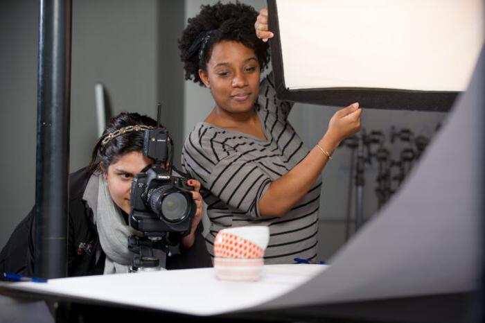 two young females working together on a shoot.