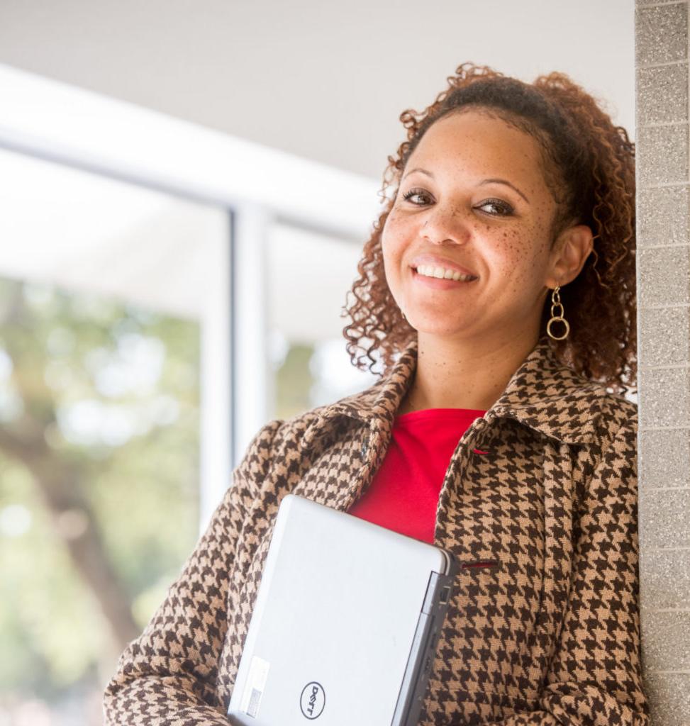 Woman holding a laptop.