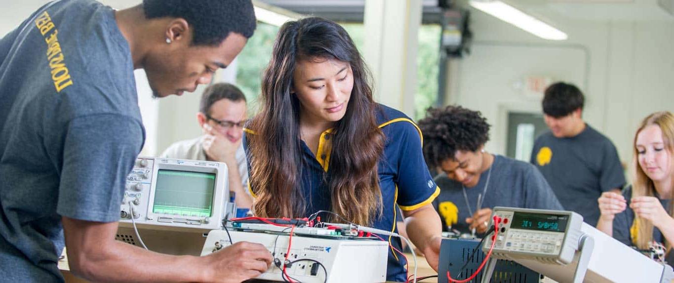 Engineering students working with equipment