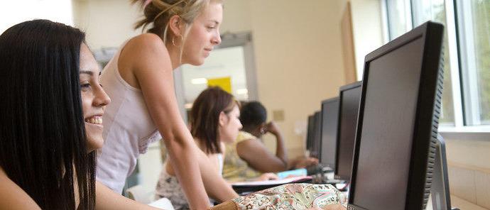 Students doing work on a computer.