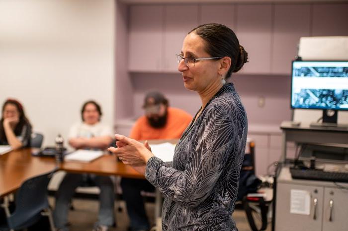 A female professor lecturing during class.