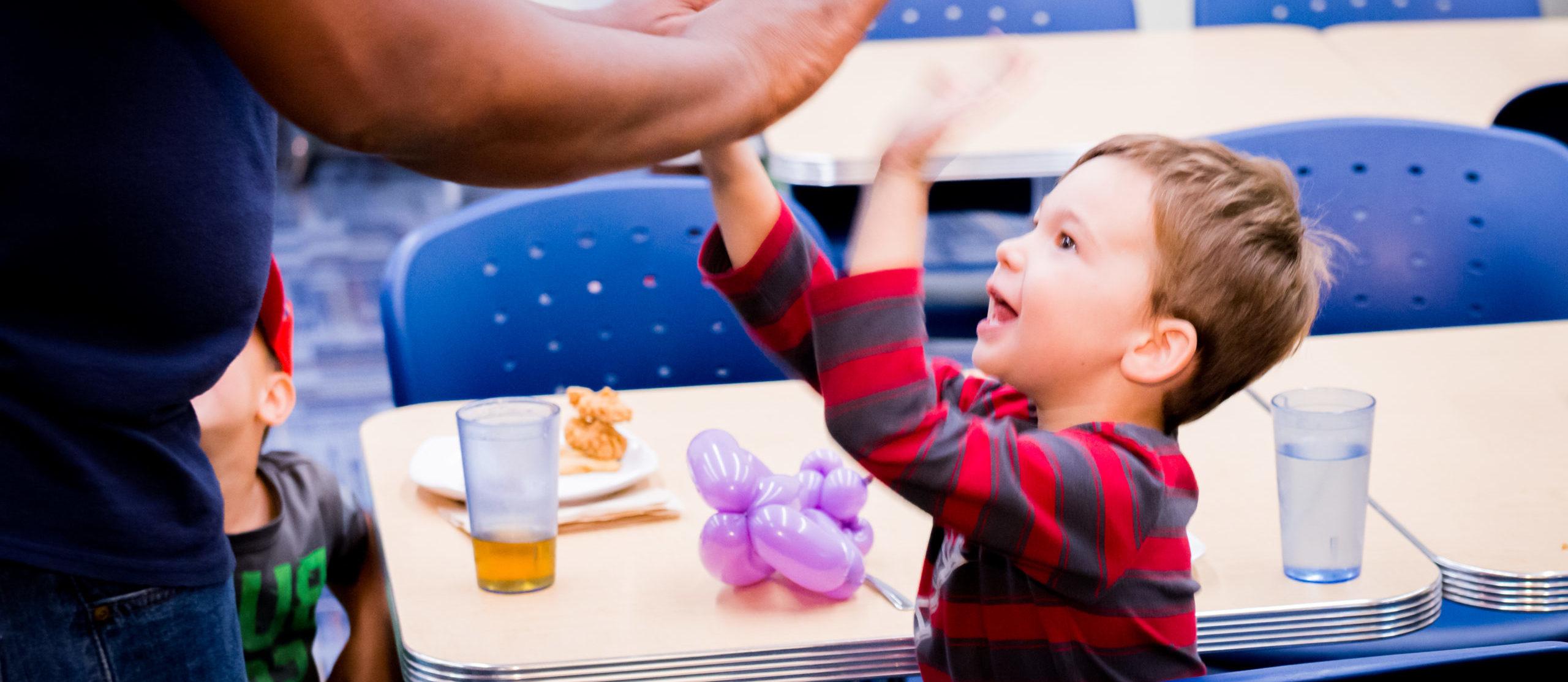 Child and social worker at a table.