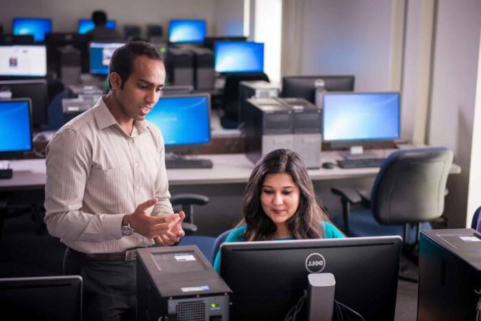 Computer science instructor helping student