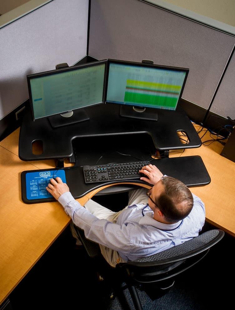 Computer scientist working at several monitors