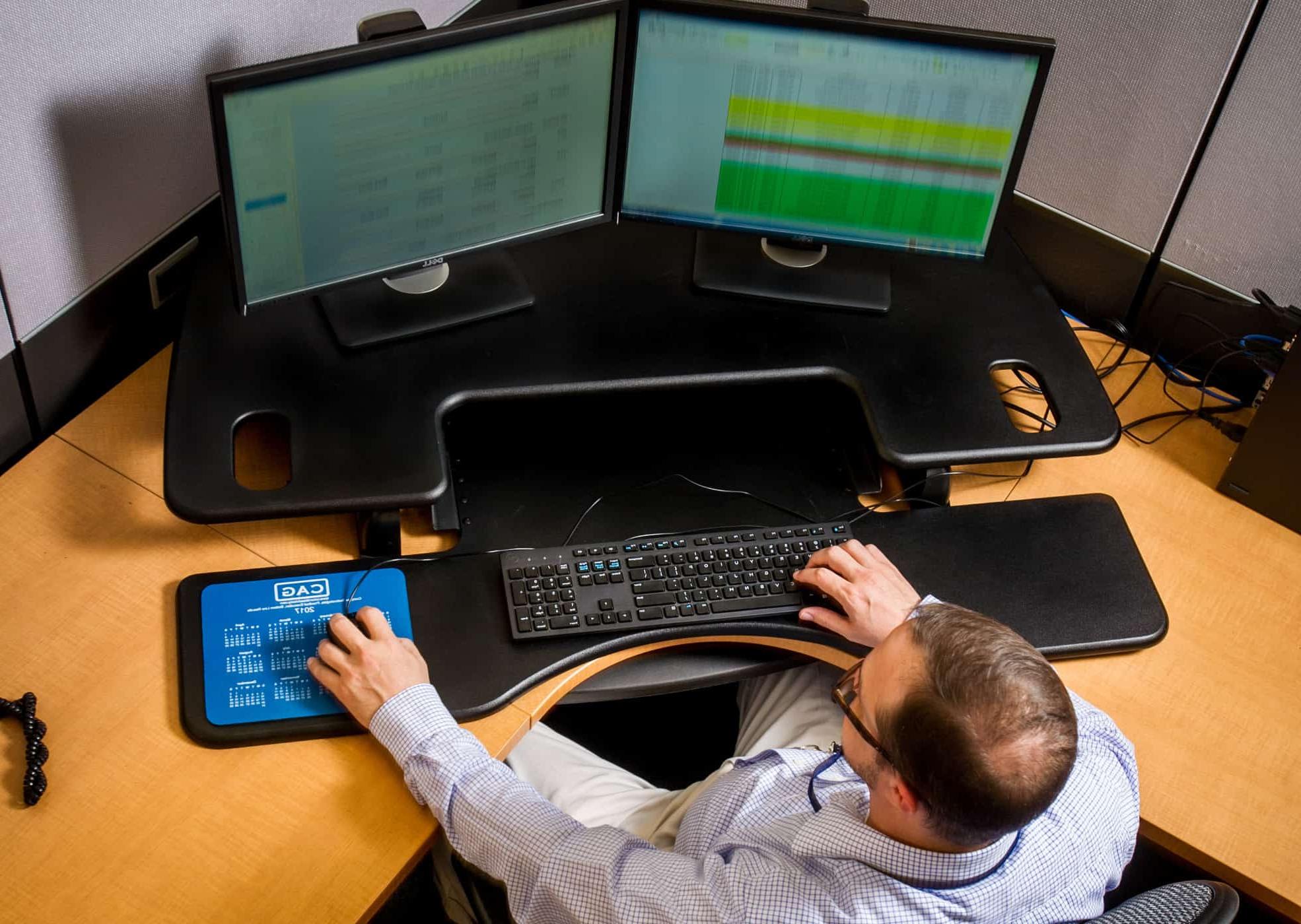 Computer scientist working at several monitors