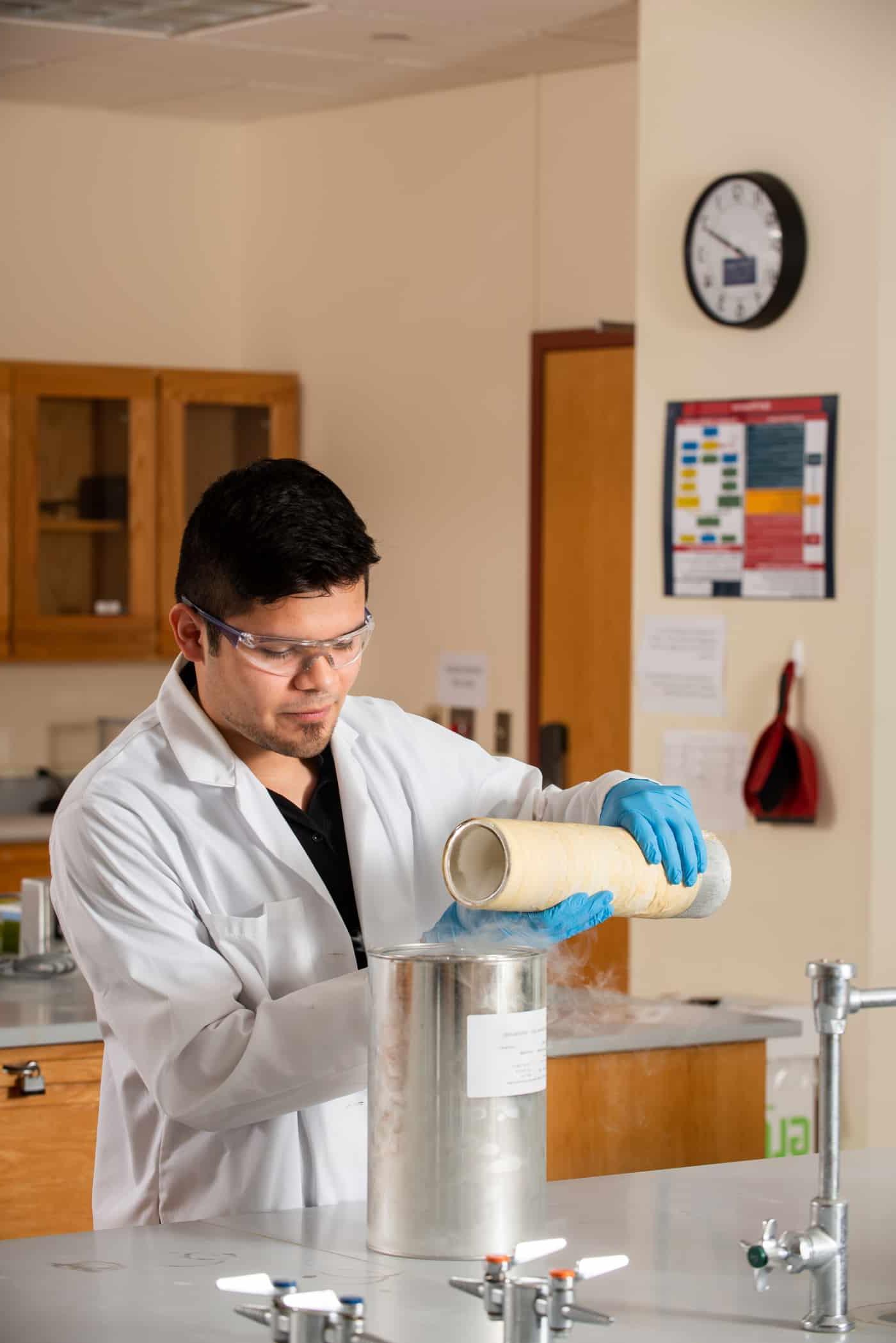 Chemist pouring liquid nitrogen into a container