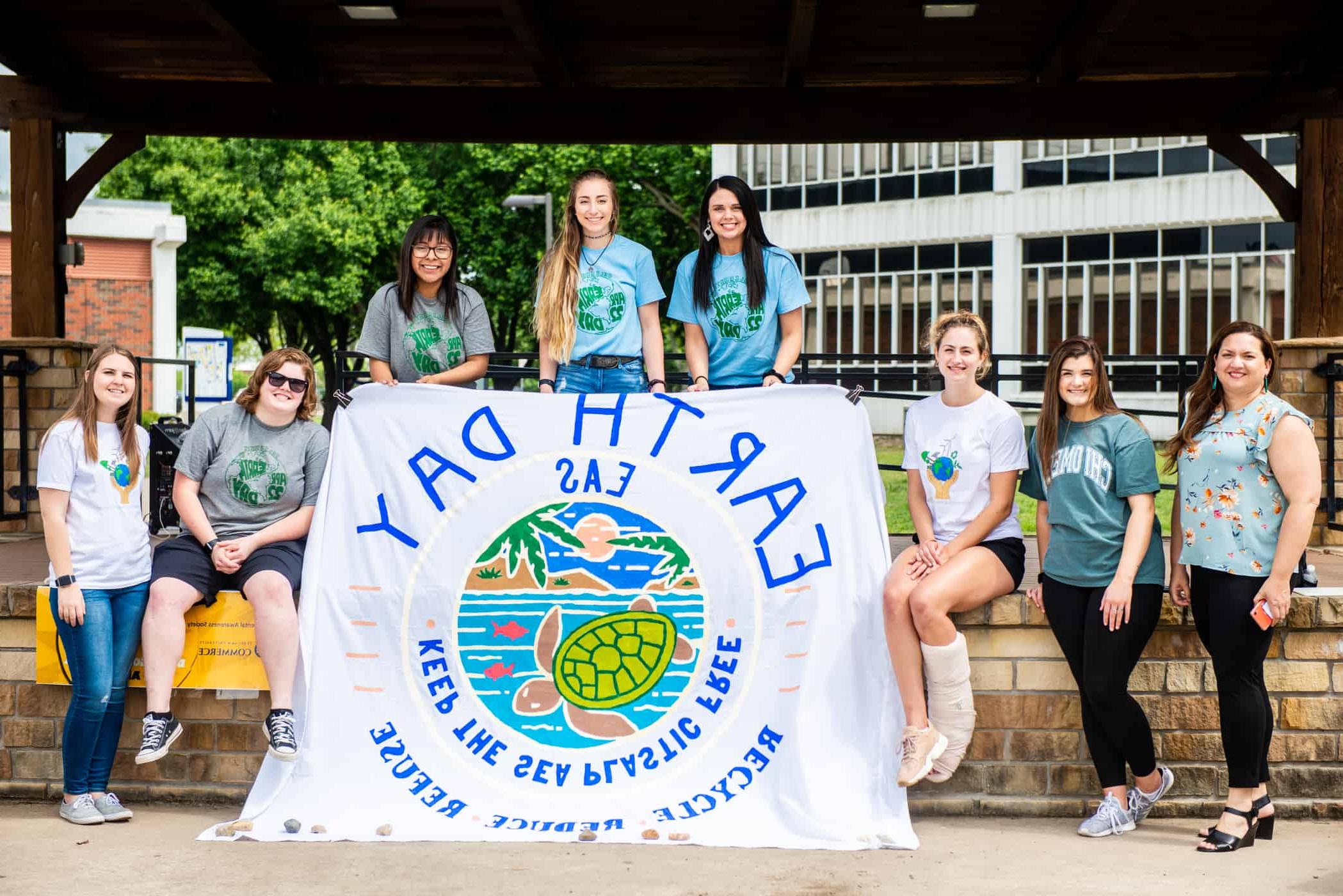 Wildlife Society students holding Earth Day banner