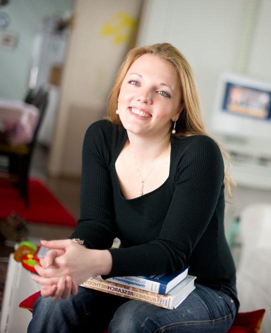 Social worker with books on a couch.