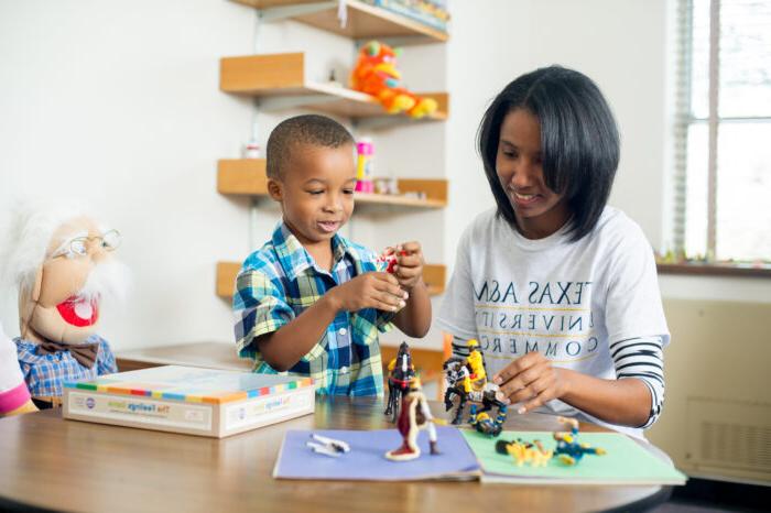 Social worker playing with a child.