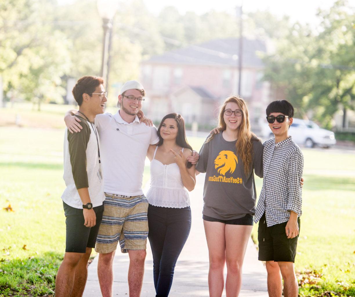 English students standing together on campus.