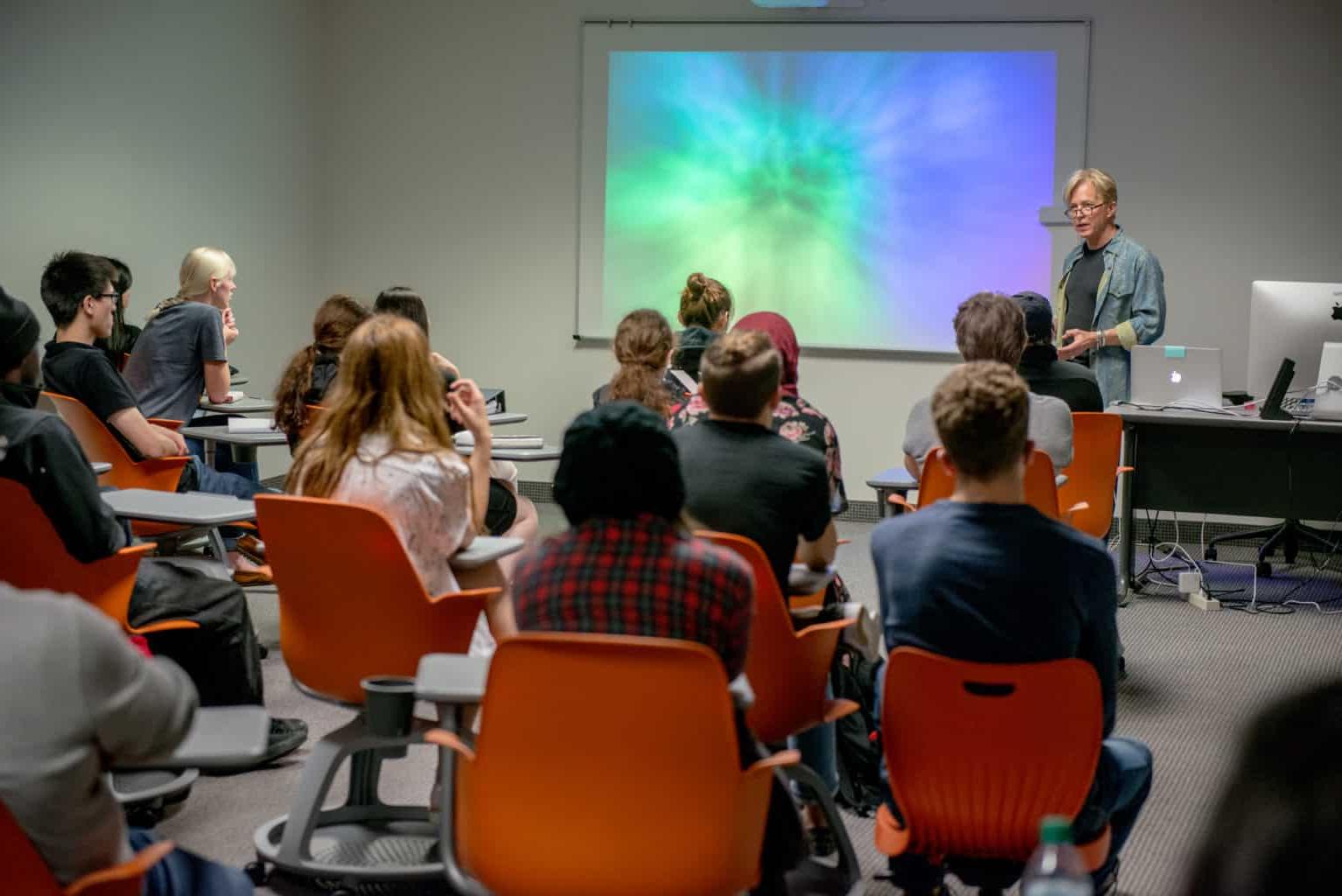 students in classroom listening to professor.