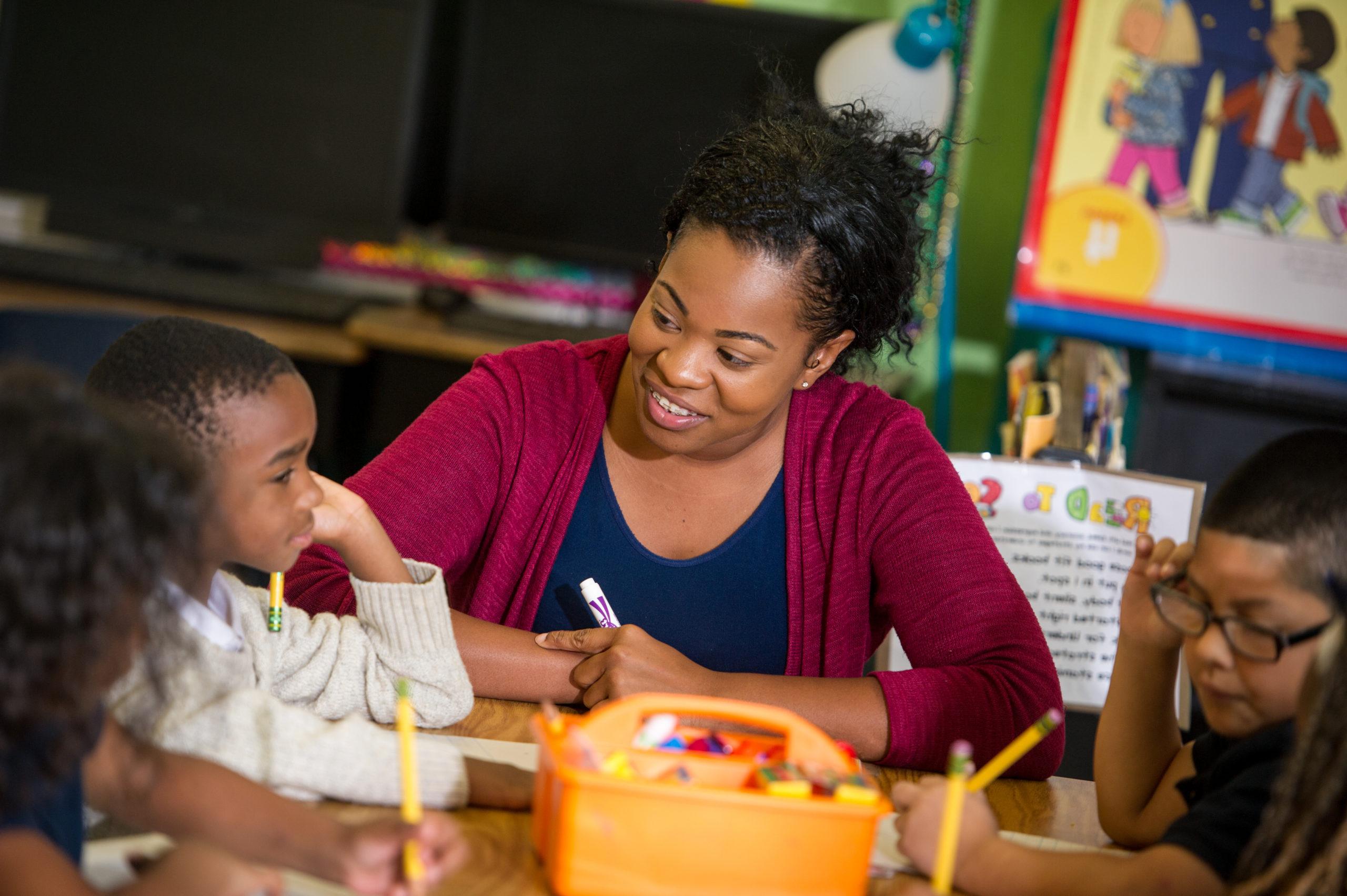 Female woman teaching young boy.