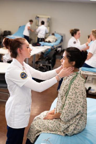 Nurse checking over a test patient.