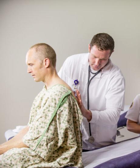 Nurse listening to patient breathing.