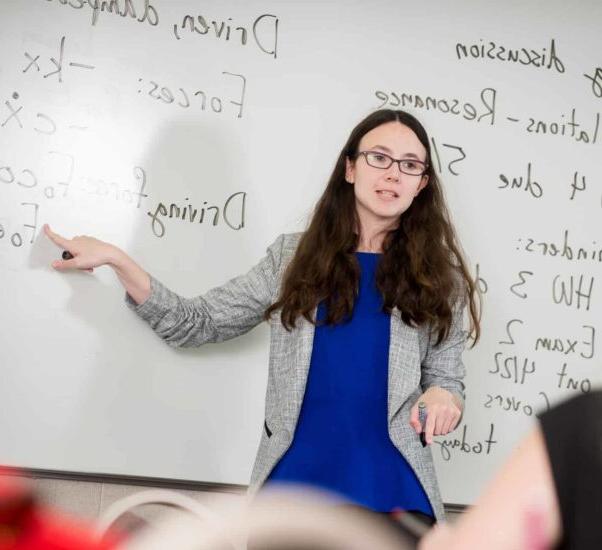 Professor actively engaged in a conversation with a student.