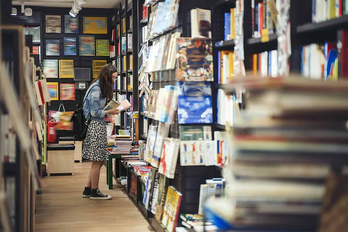 Female student searching for books in the book store.