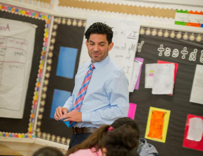 Male teacher in elementary classroom.