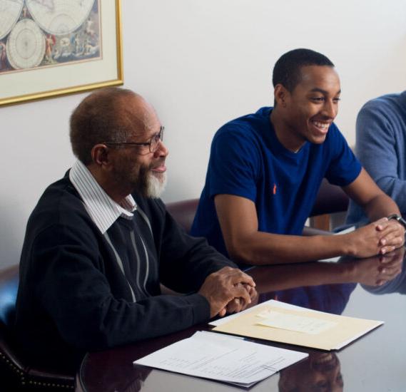 Two men around conference table.