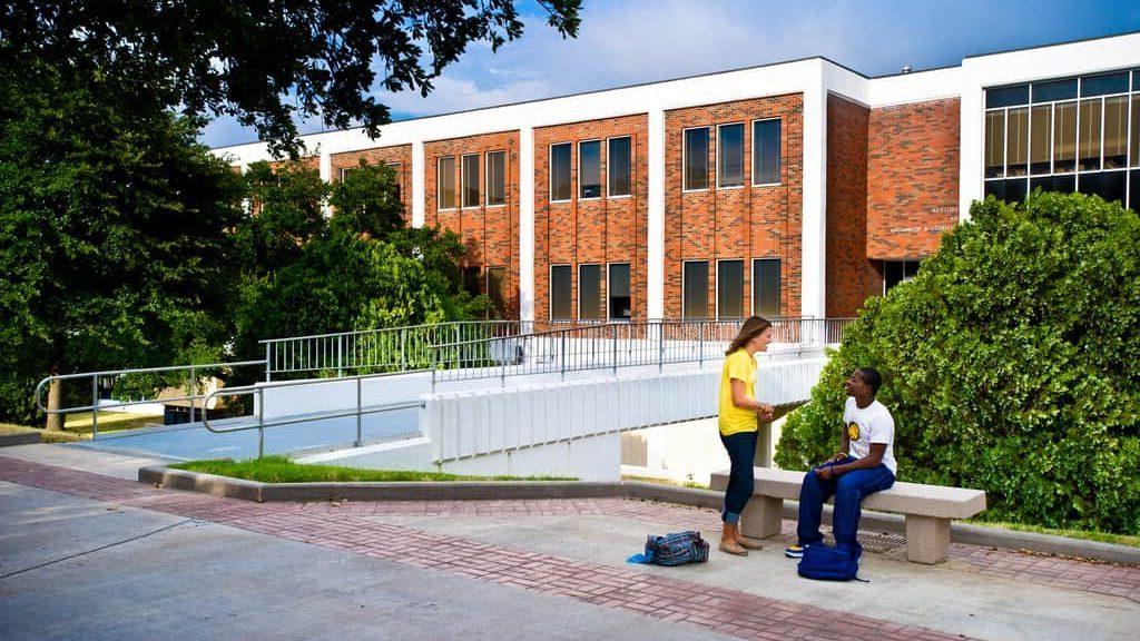 students interacting background 'McDowell Administration Building'.