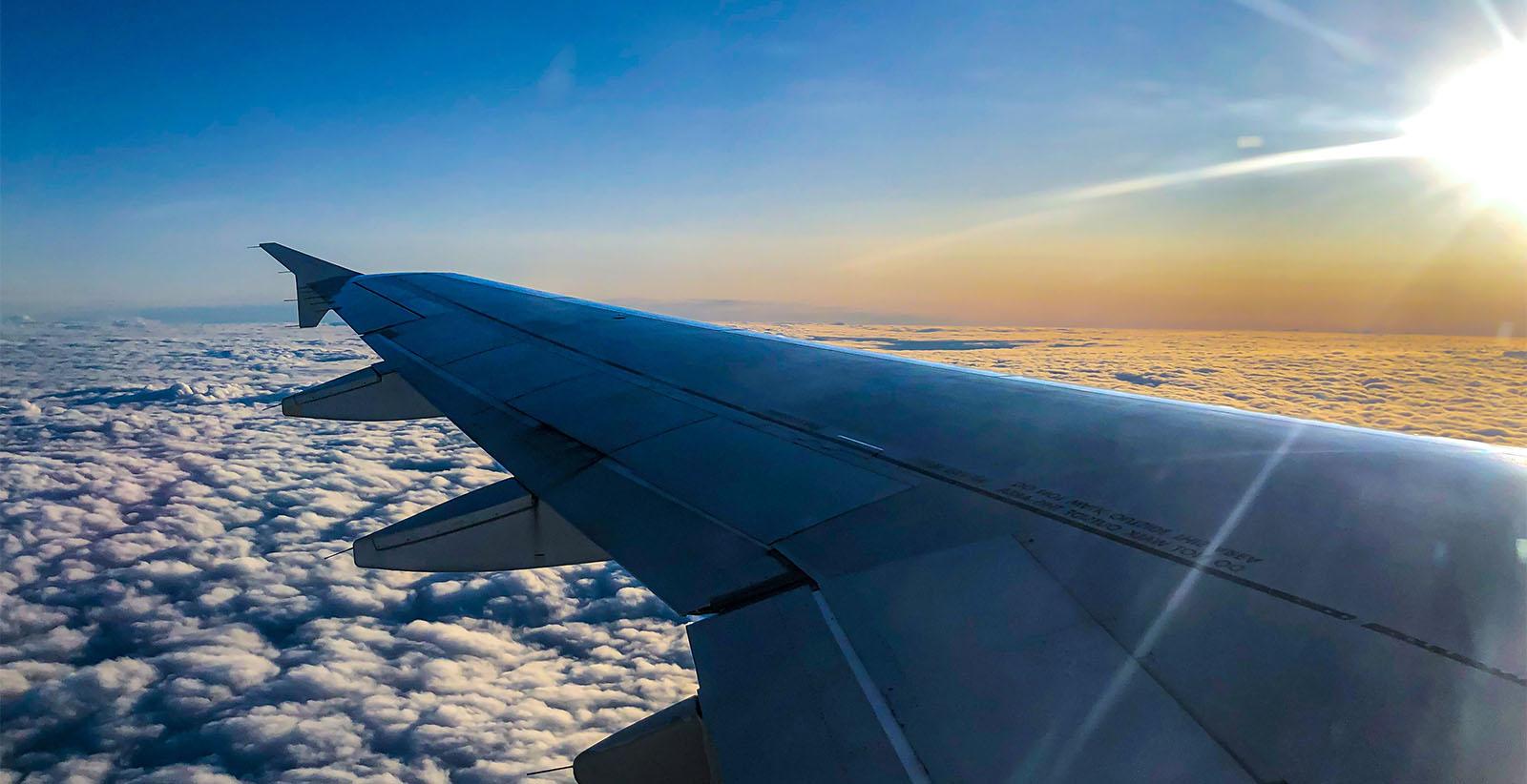 Plane wing in the clouds.