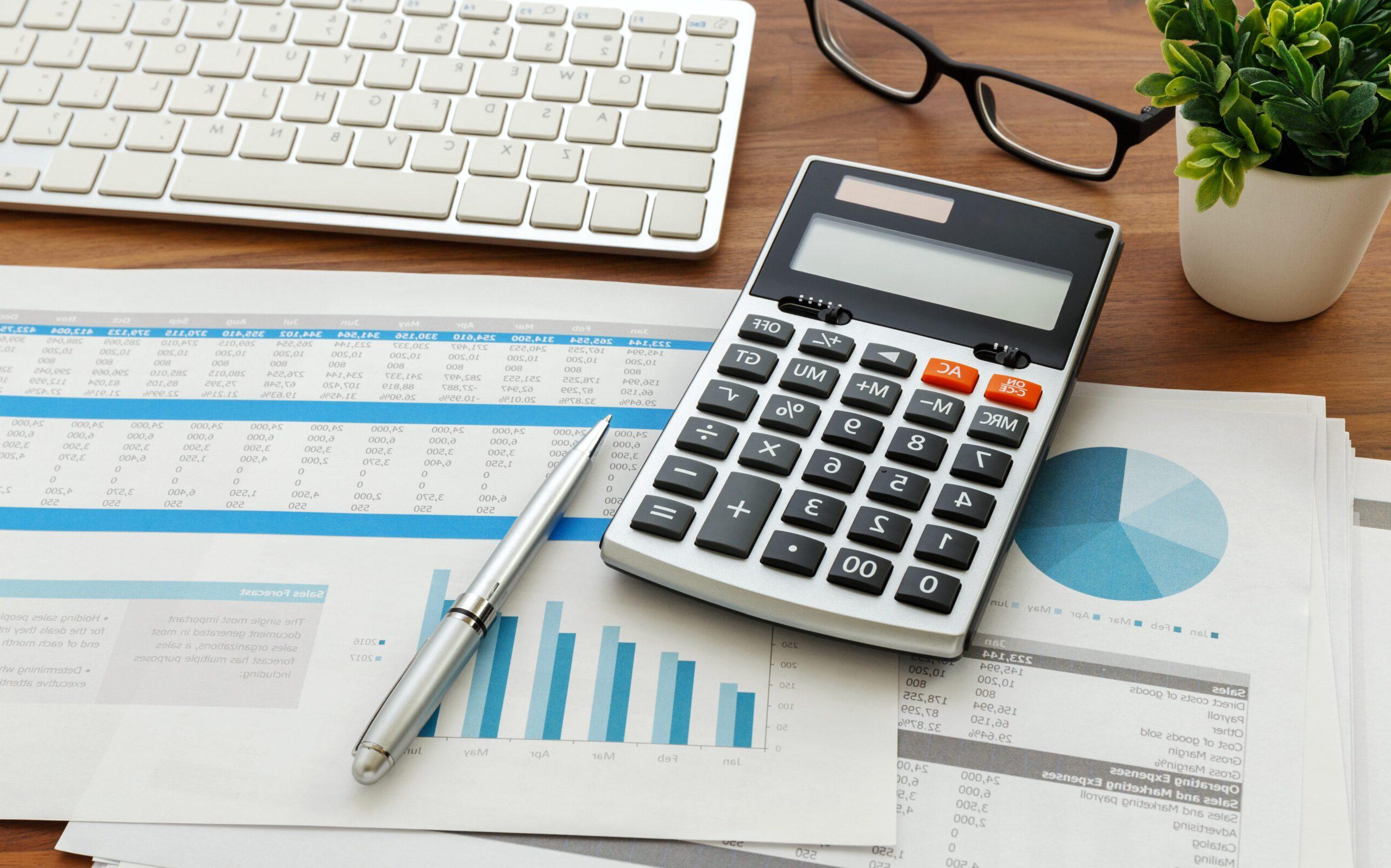 Financial accounting with calculator and financial chart  data and computer keyboard