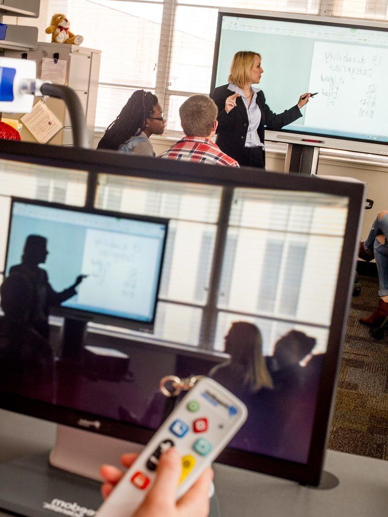 Professor presenting assistive technologies in a class.