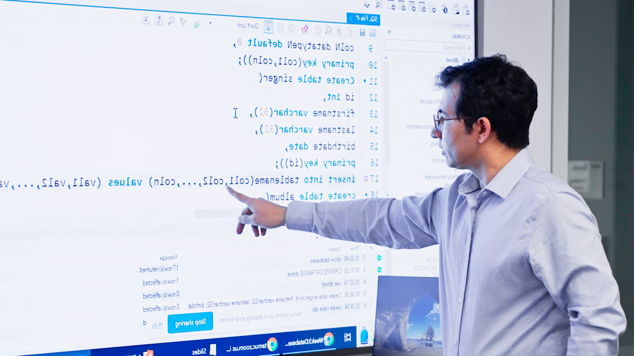 man looking at projection of code