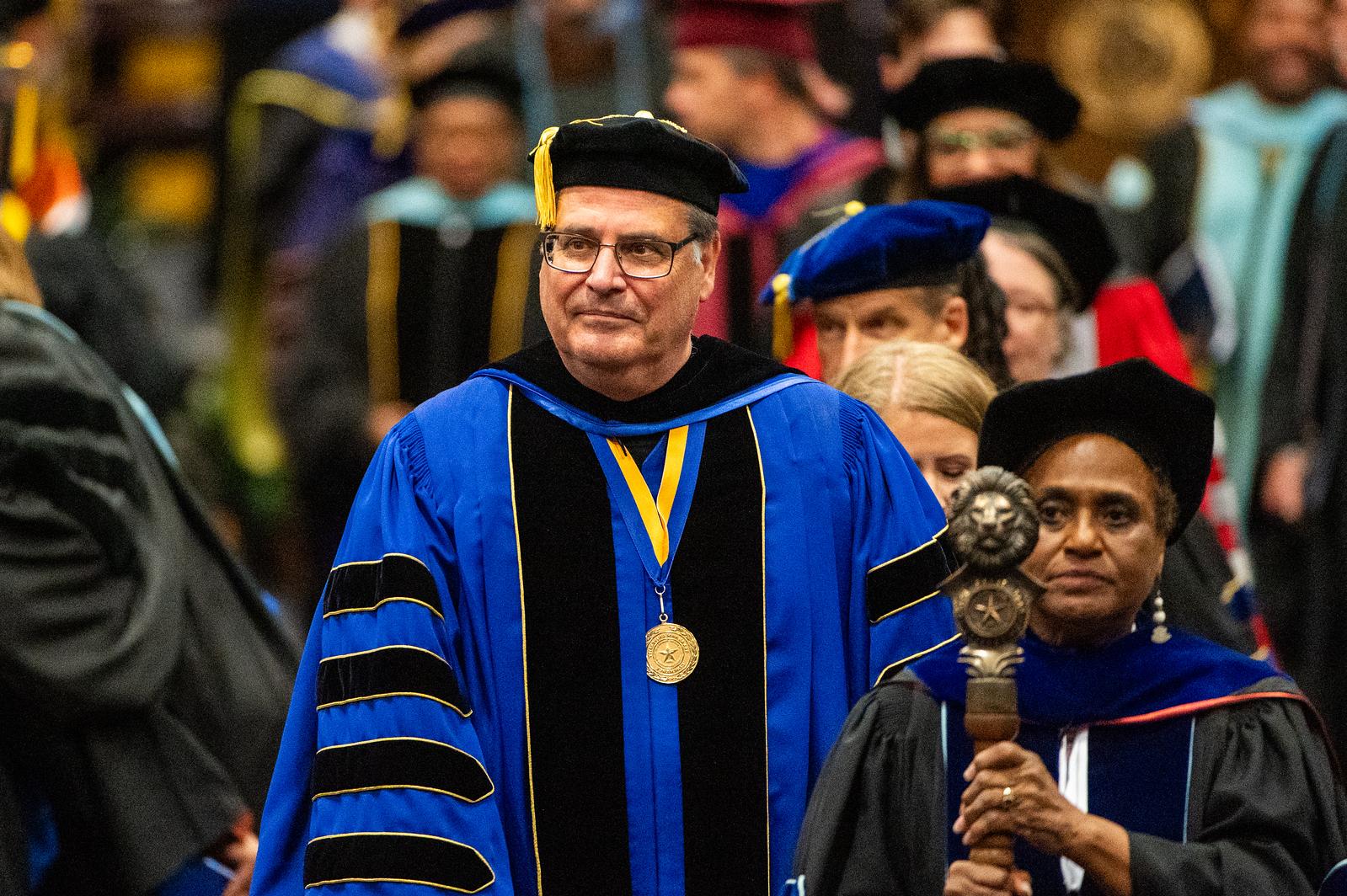 President Rudin in graduation regalia proceeding into the ceremony